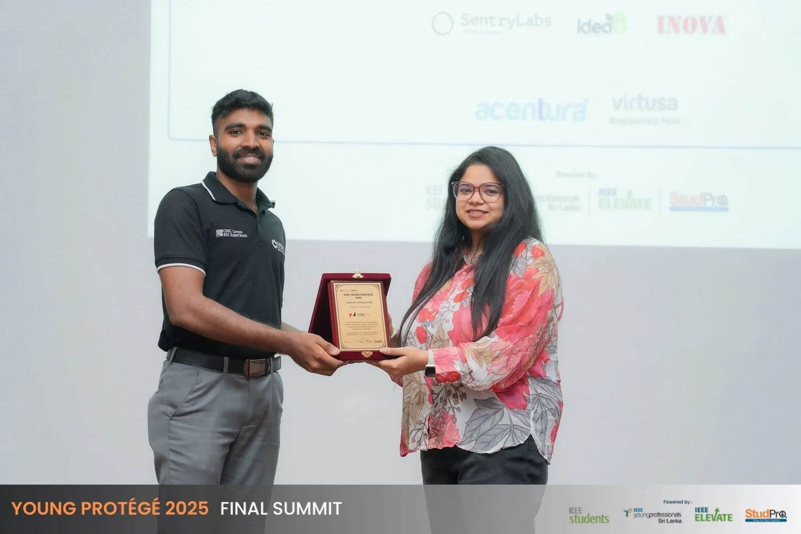 Pamudi Dahanayake on stage receiving the IEEE Young Protégé 2025 token of appreciation.